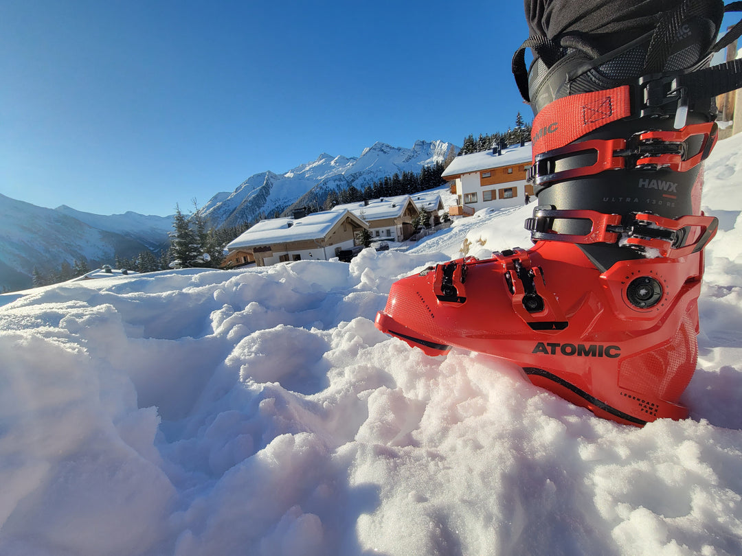 Atomic ski boot against Austrian Alps. Sleek design, advanced features. Majestic backdrop for thrilling skiing. Adventure, performance, and beauty in one captivating image.